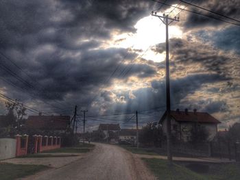 Power lines against cloudy sky