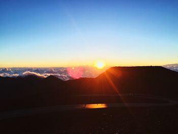 Scenic view of silhouette mountains against sky during sunset