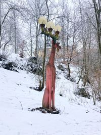 Bare tree on snow covered field