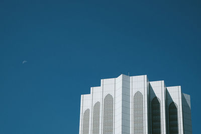 Low angle view of modern building against clear blue sky