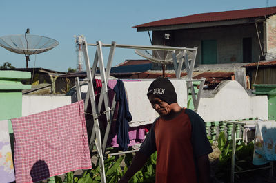 Rear view of man standing against building