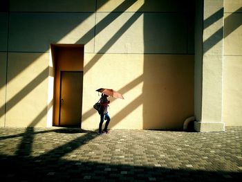 Full length of boy with shadow on floor