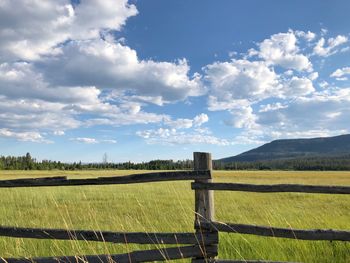 Fence on field against sky