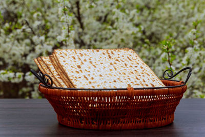 Crackers in wicker basket on table outdoors