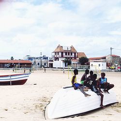 People on beach against sky