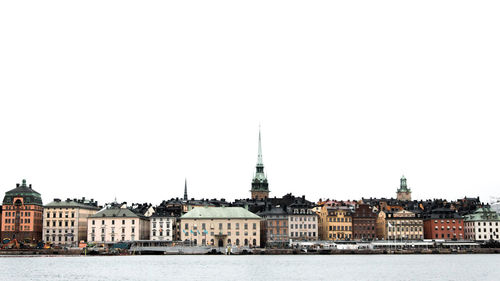 Buildings in city against clear sky