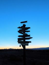 Low angle view of silhouette cross against clear sky during sunset