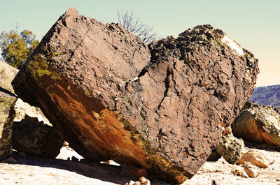 Rock formations in sea against clear sky