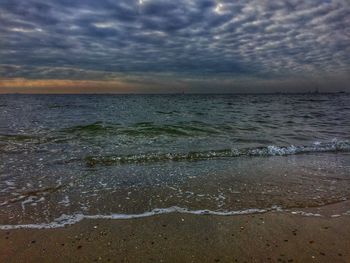 Scenic view of sea against cloudy sky