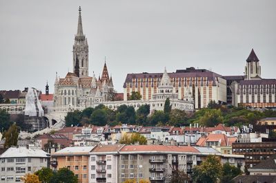 Buildings in city against sky