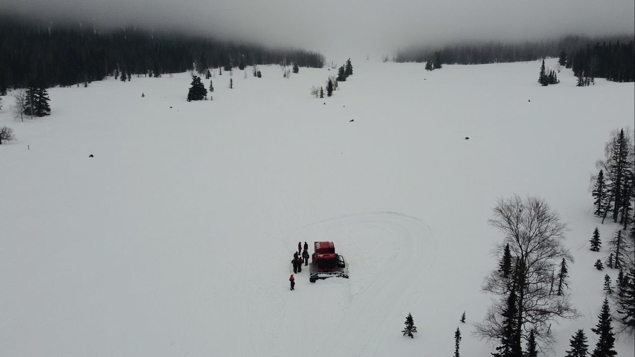 PEOPLE ON SNOW COVERED FIELD