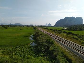 Panoramic shot of railroad tracks on land against sky