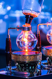 Close-up of illuminated wine glass on table