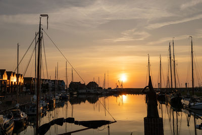 Sailboats in marina at sunset