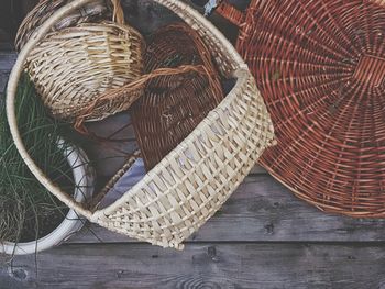 High angle view of wicker baskets on wooden table