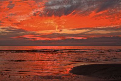 Scenic view of sea against orange sky