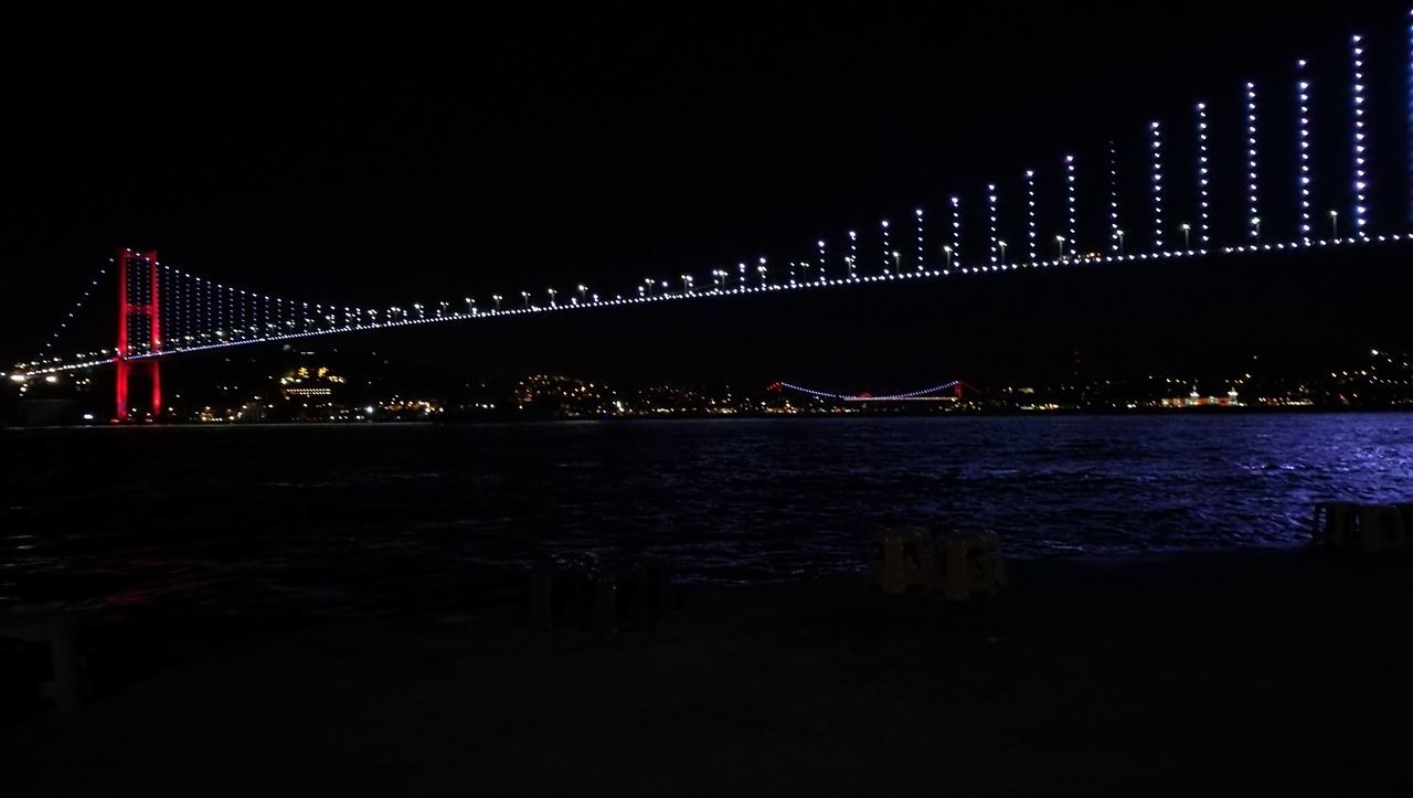 ILLUMINATED BRIDGE OVER RIVER