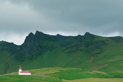 Scenic view of mountains against cloudy sky