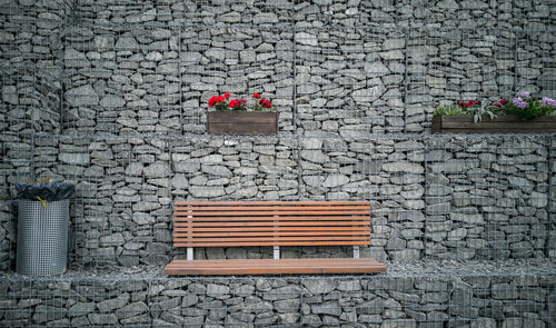 Empty chairs against brick wall