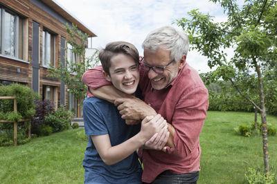 Playful father and son in garden