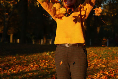 Hello autumn. happy blonde elegant 40 year old woman in yellow pullover, shawl outside enjoying 