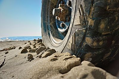 Close-up of rock on beach against sky