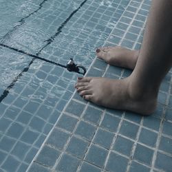 Low section of woman in swimming pool