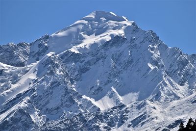 Scenic view of snowcapped mountains against clear blue sky