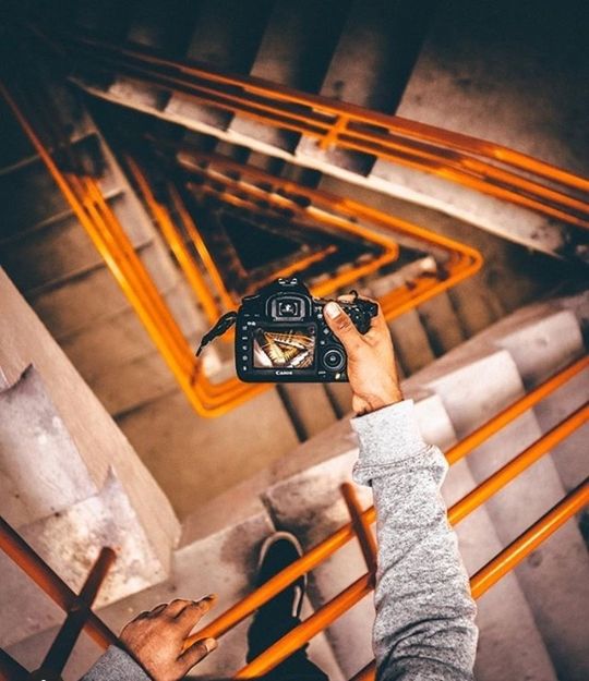 holding, one person, technology, high angle view, human hand, real people, focus on foreground, human body part, indoors, hand, wood - material, photography themes, camera - photographic equipment, unrecognizable person, close-up, day, directly above, retro styled, photographer