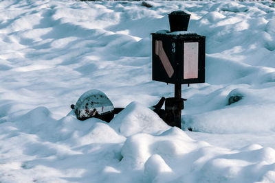 Information sign on snow covered land