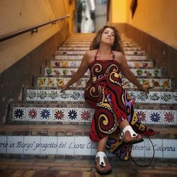 Woman sitting on staircase