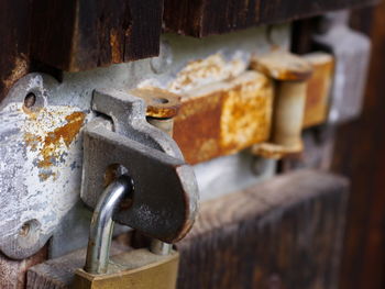 Close-up of padlock on rusty metallic door