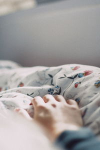 Close-up of woman resting on bed