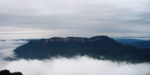 Scenic view of mountains against cloudy sky