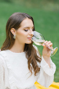 Woman with a glass of wine dreams, happy girl drinking wines person