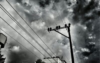Low angle view of electricity pylon against sky