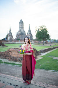 Woman in temple against sky