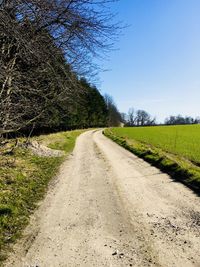 Dirt road along countryside landscape