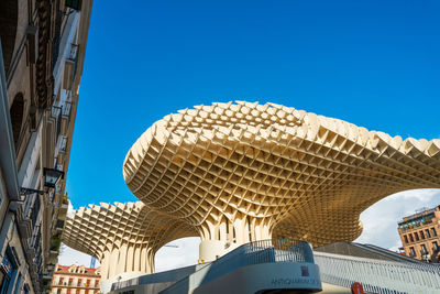 Low angle view of buildings against clear blue sky