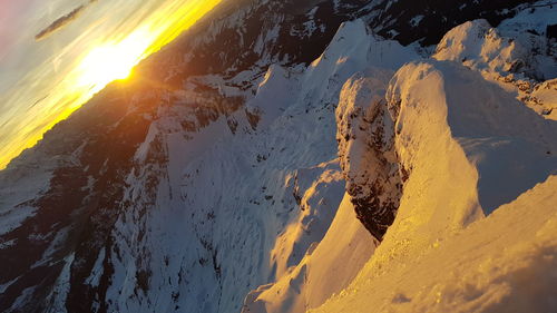 High angle view of snowcapped mountain during sunset