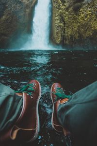 Low section of man at waterfall