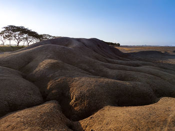 Scenic view of arid landscape against clear sky