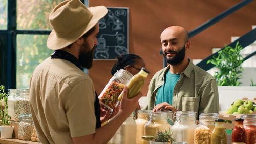 Side view of senior man drinking water while standing in cafe