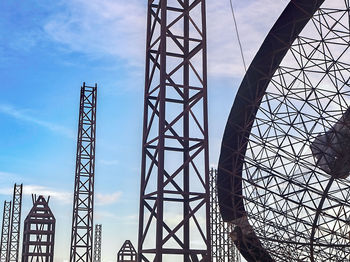 Low angle view of metal tower against sky