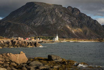 Scenic view of sea and mountains against sky