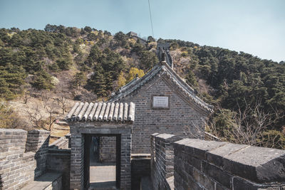 Exterior of old building by mountains against clear sky