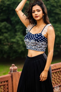 Portrait of a beautiful young woman standing outdoors