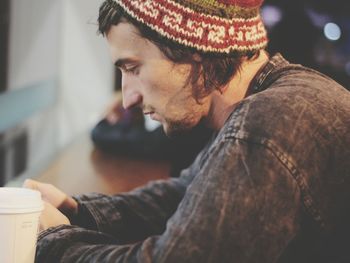 Close-up of young man using mobile phone