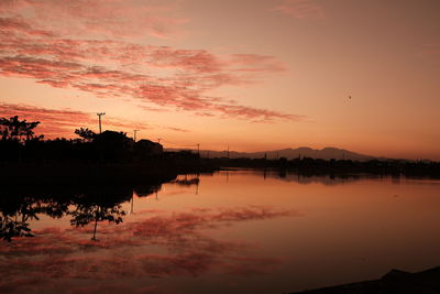 Scenic view of lake against romantic sky at sunrise