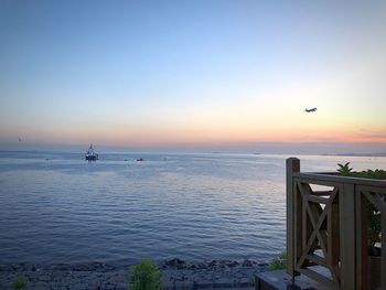 Scenic view of sea against clear sky during sunset